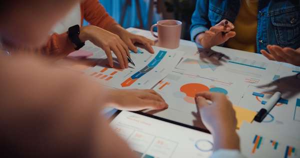 What We Do 3 business team analyzes data charts at modern offic 2026 09 21 02 22 31 utc
