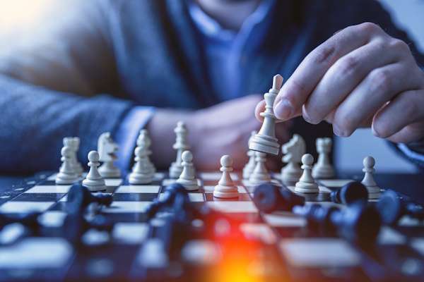 About Us 1 strategic move chess piece held by adult hand 2026 09 23 13 16 50 utc